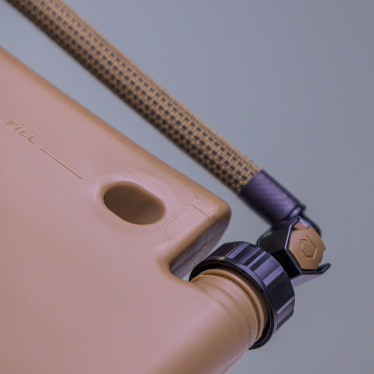 Close up of ICECAP Gen 3 connecting Source 90 Drink Tube to ICEPLATE® Gen 3 in Coyote Brown